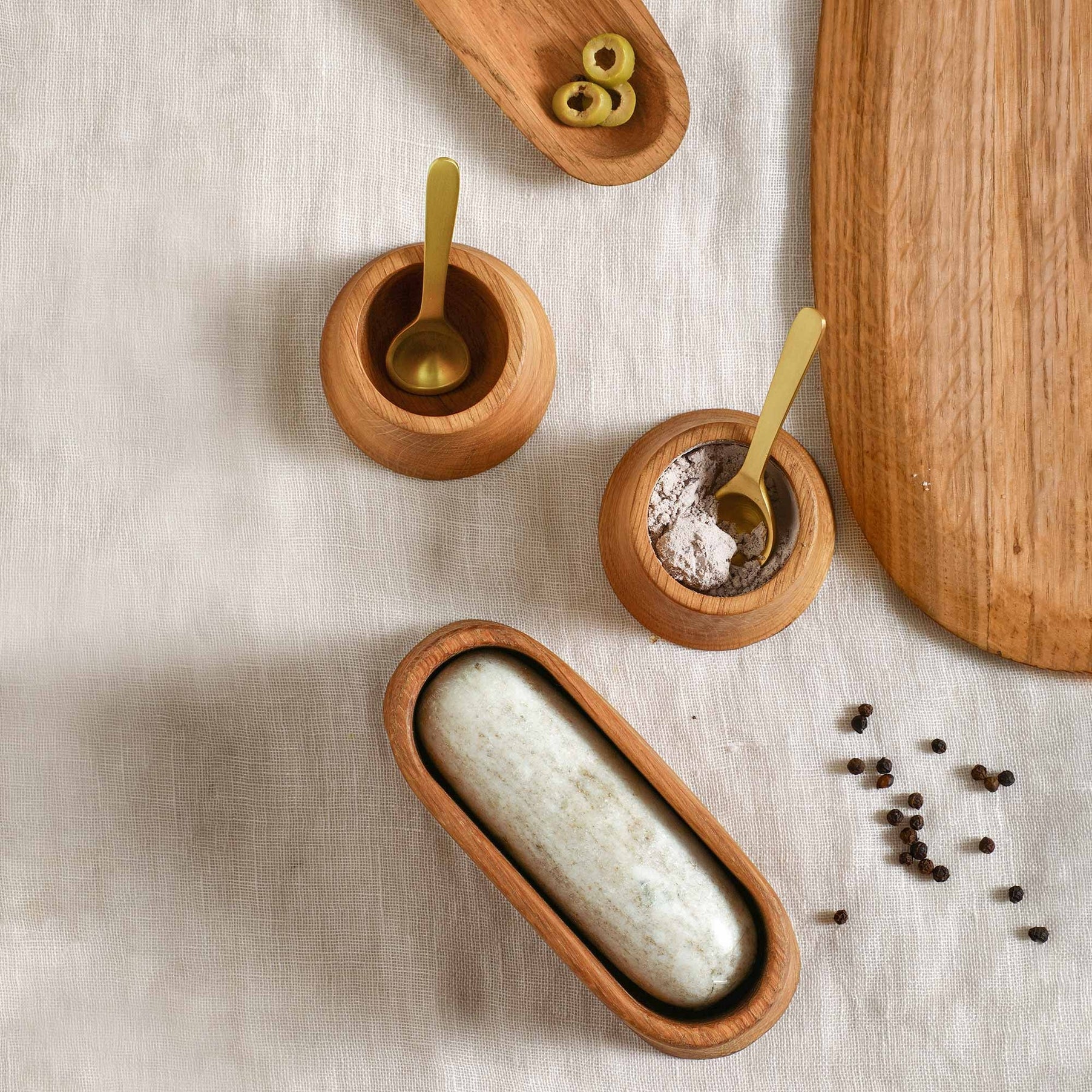 Premium French oak is shaped by hand into these tower-shaped pinch bowls, which are just right for offering salt and pepper or other condiments on the table.

Includes a pair of diminutive matte brass spoons for serving.