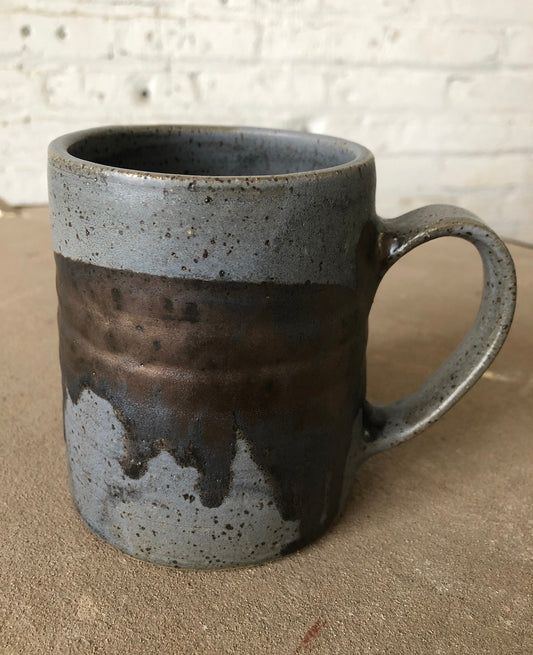 Handmade ceramic mug crafted in a brown stoneware clay with speckles with a semi matte glaze with bronze accents.