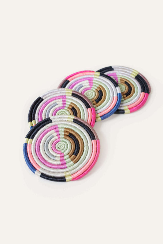 Add a modern pop of color to your home with this multicolored set of 4 coasters. These coasters are the perfect tabletop item for entertaining, gifting giving, or curating a unique table setting for your indoor and outdoor dining. Handcrafted in Rwanda with a time-honored weaving technique.