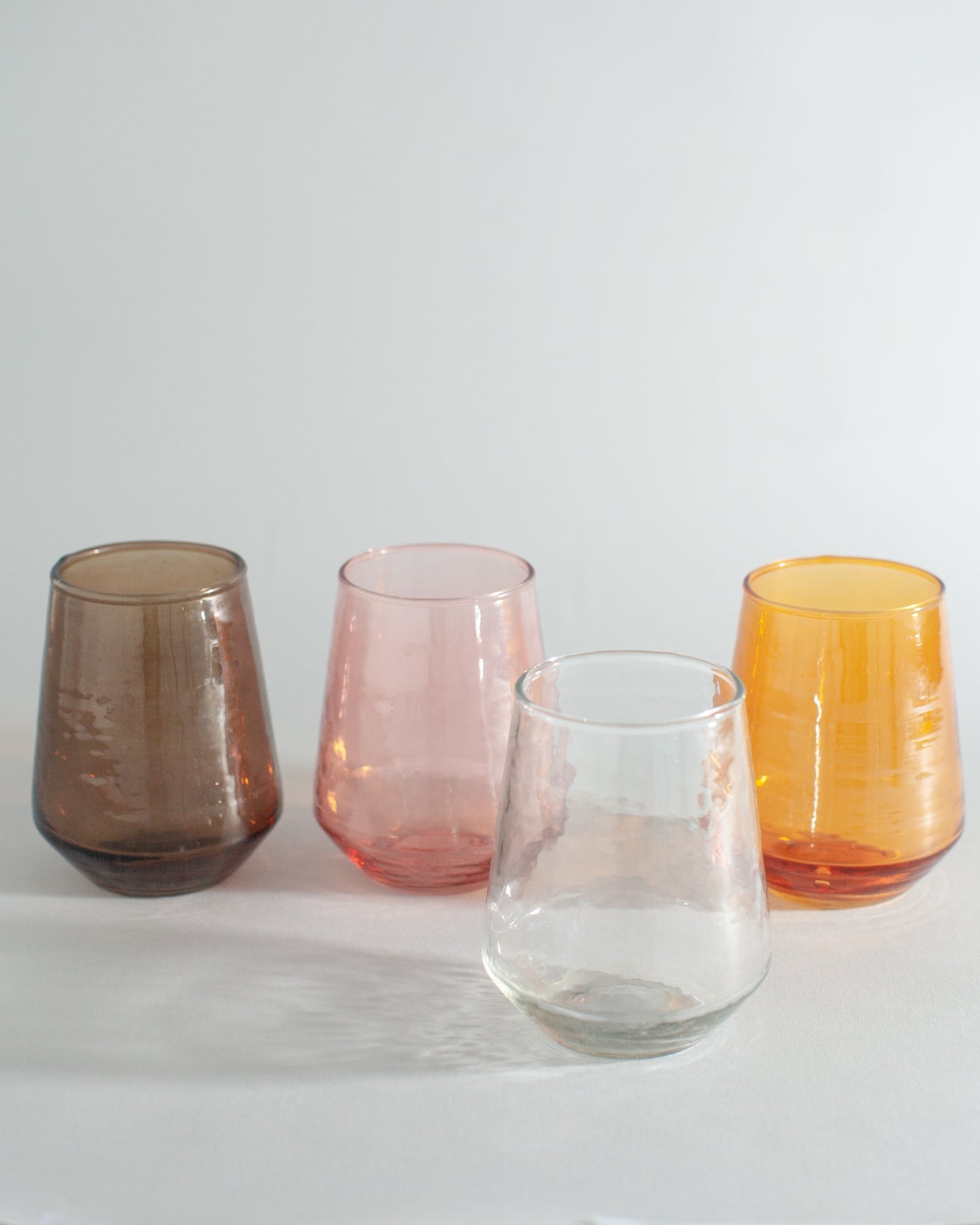 Sip in style with these handblown hammered glass tumblers. Handcrafted from 100% recycled colored glass.