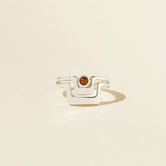 Lindsay Lewis Grand Ring. Soft angles and negative space come together for one ring that gives the illusion of two. Made with sterling silver and features a translucent tan Czech glass cabochon.
