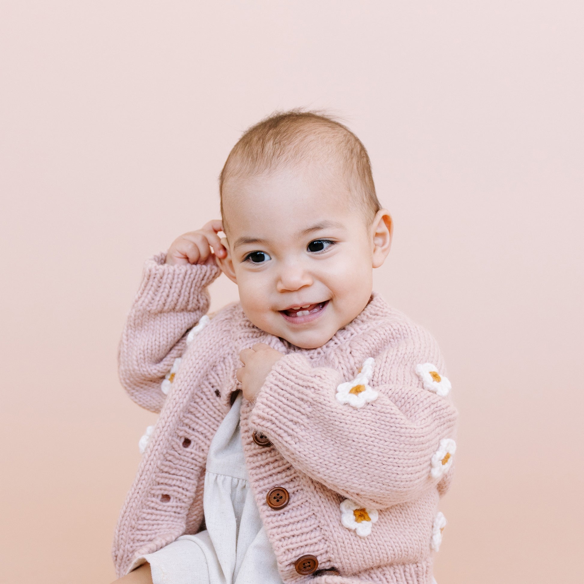 Stroll through fields of flowers with the Flower Cardigan in Blush. Featuring Cream hand-crochet flowers. Crafted with care using 100% Hand-knit Acrylic