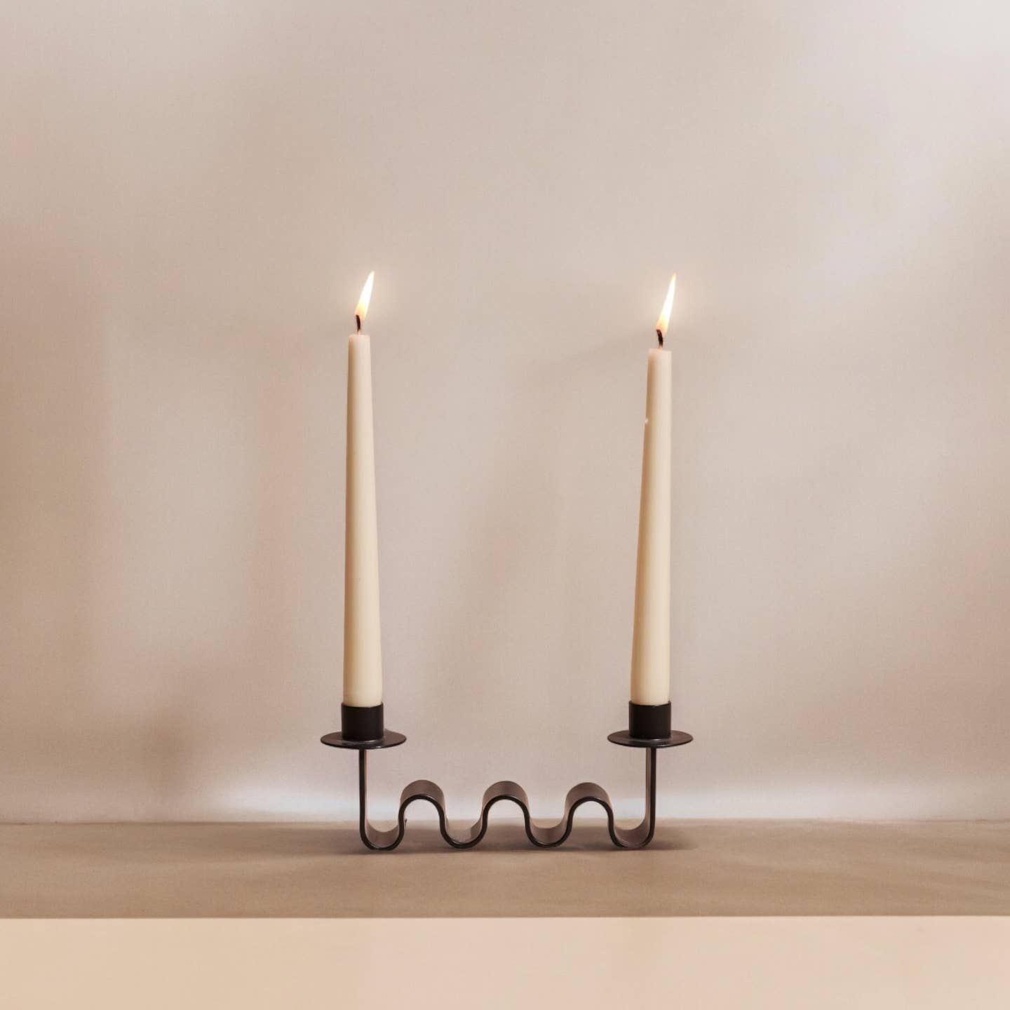 Wavy Black metal candle holder for two taper holders.

Designed by Diego Olivero.