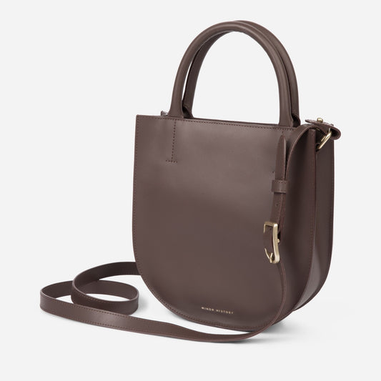 Whether exploring the city or jet-setting on a weekend getaway, the ARC II is the perfect companion. This essential hands-free leather crossbody bag combines our signature architectural approach with an adjustable, removable strap and top handles for one bag that does it all. The signature structured leather and solid brass hardware give it a refined finish. &nbsp;