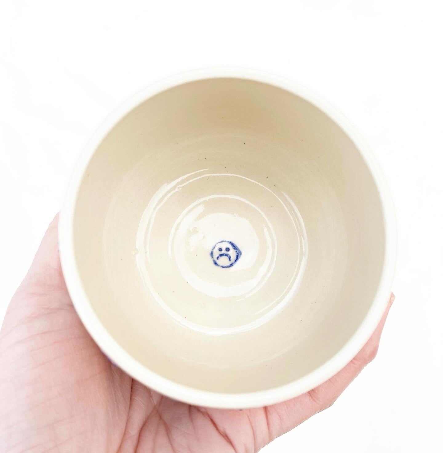 Hand-thrown cream stoneware with alternating happy sad faces in cobalt. Made in Virginia, USA by Korai Ceramics.