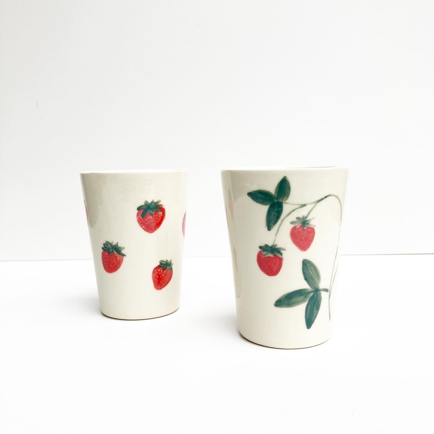 Slip casted ceramic cups in dover white (off white) and hand painted with strawberries. Handmade by Alicja in her Vermont studio.