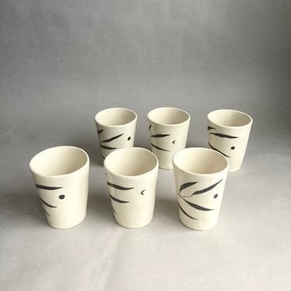 Slip casted ceramic cups in dover white (off white) and painted with black underglaze. Each cup is a little different. Some have full and some have a crescent moon. Handmade by Alicja in her Vermont studio.