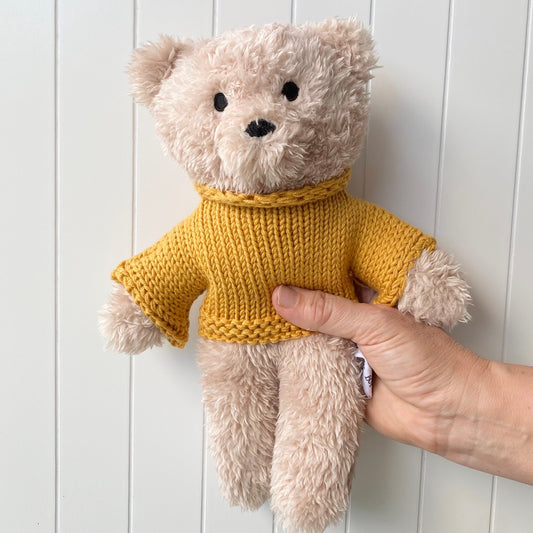 Dulice bear is made with a creamy vanilla super soft plush fabric and wears a mustard knitted jumper made from Australian merino wool. Australian designed.