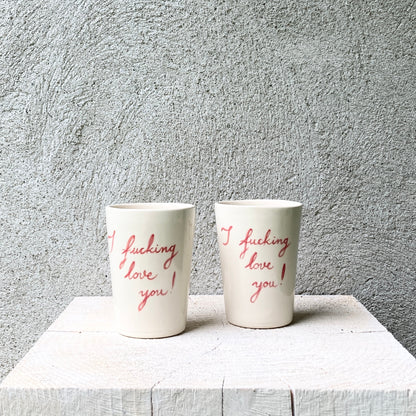 Slip casted cups in dover white (off white) and painted with red letters "I fucking love you!".


Freely hand painted.