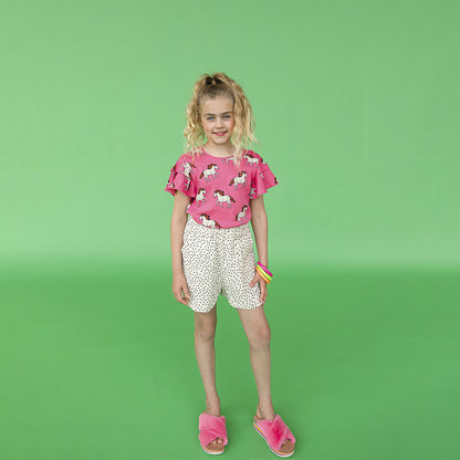 A pink top printed with horses - round neck with ruffle shoulders for fluid movement. Ethically produced, colorful and fun with an eye towards comfort, style and joy. Modern and sustainable kids clothing by CarlijnQ of the Netherlands.