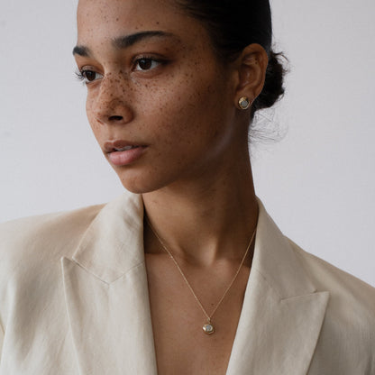 Nestled delicately within the organically shaped three-pronged Keeper pendant, the Mother of Pearl radiates its tranquil aura. Handmade in Northern California by Amanda Hunt.