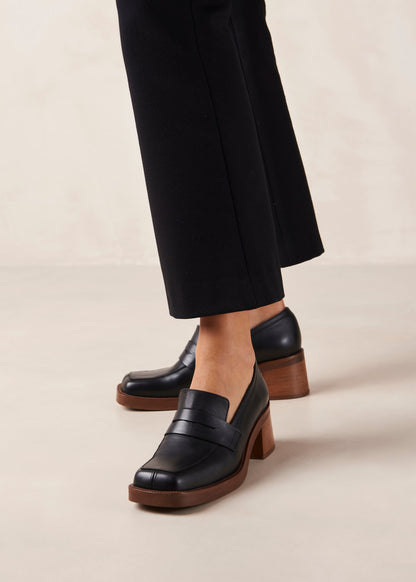 If you are always game for extra height, Roxanne is the loafer-pump hybrid you have been craving for. Think your evergreen moccasin silhouette set atop a chunky block heel for a little flattering elevation. They come in premium black leather and feature the classic penny tab across the vamp. Sustainably made in Spain. Alohas Roxanne Black Leather Loafer.