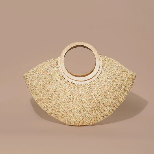 indego africa / The Iba Braided Raffia Moon Tote is a geometric handbag that provides a playful statement to any outfit. This summer-ready handbag can be styled casually or dressed up as a unique piece that also has plenty of interior capacity.