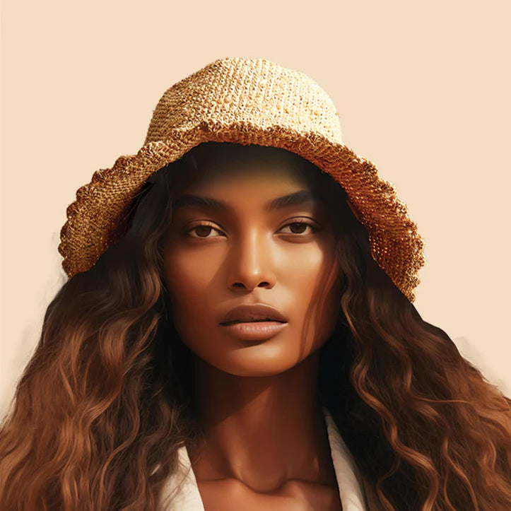 The Rwama Packable Raffia Bucket Hat is the perfect summer accessory. The scalloped brim elevates the classic bucket hat shape while crocheted raffia adds texture and durability.