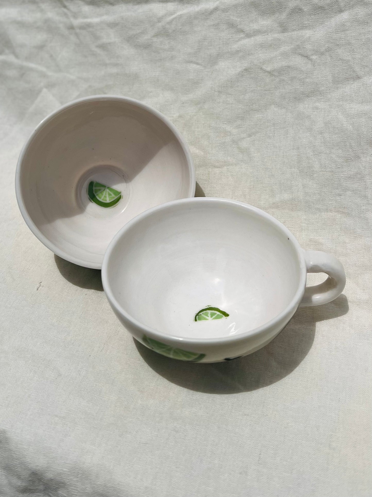 Handmade porcelain mug with hand painted limes. Made right here in Encinitas, California by Chandler Puritty. With its satisfying and ergonomic design, I think it's impossible not to feel good holding this mug and sipping your favorite tea or coffee.