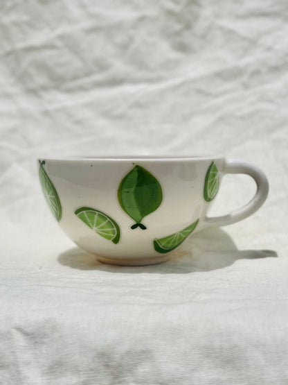 Handmade porcelain mug with hand painted limes. Made right here in Encinitas, California by Chandler Puritty. With its satisfying and ergonomic design, I think it's impossible not to feel good holding this mug and sipping your favorite tea or coffee.