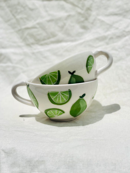 Handmade porcelain mug with hand painted limes. Made right here in Encinitas, California by Chandler Puritty. With its satisfying and ergonomic design, I think it's impossible not to feel good holding this mug and sipping your favorite tea or coffee.