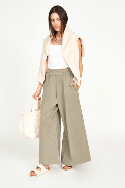 Wide leg, full length pant with an elastic waistband. Made of lightweight jersey with brushed fleece inside. Naturally dyed with Kaddukai, often used in Ayurveda. Ethically made in India. Mirth lounge pant in sagebrush