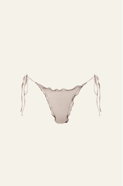 The Melting Bottom features a ruched back with delicate ruffle detail on the sides. This bottom features a cheeky coverage and adjustable side ties for a perfect fit. 88% Recycled Polyamide | 12% Elastane | OKEO TEX Standard - Designed & crafted in Barcelona, Spain.