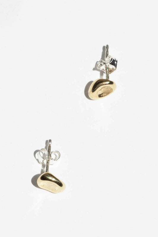 The Puddle stud is inspired by a calm small body of water. Perfect alone or in a second ear piercing.   Hand carved and cast with a high polished mirror finish. Available in solid brass or sterling silver.