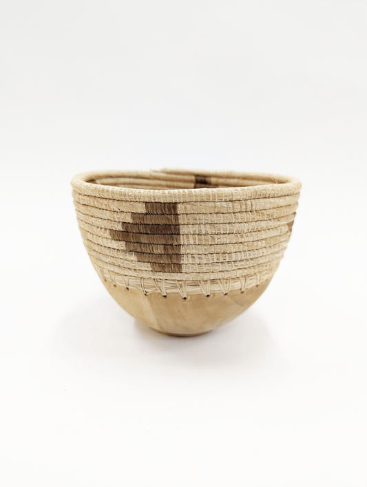 This mini bowl elevates a space no matter the contents it is holding, Can be used to store everything from your favorite jewelry, to your keys, and more! Hand-carved and handwoven with care in Rwanda.