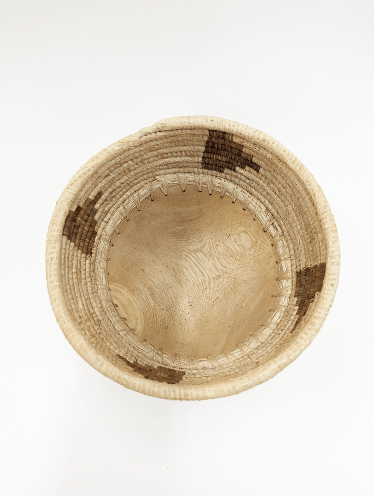 This mini bowl elevates a space no matter the contents it is holding, Can be used to store everything from your favorite jewelry, to your keys, and more! Hand-carved and handwoven with care in Rwanda.