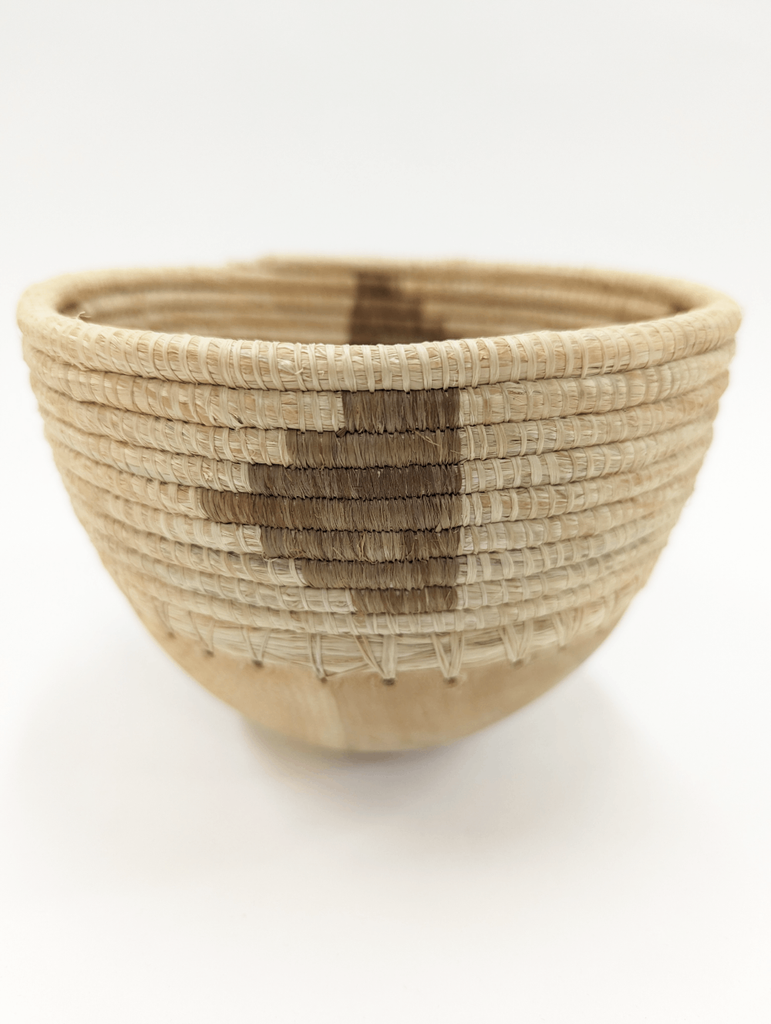 This mini bowl elevates a space no matter the contents it is holding, Can be used to store everything from your favorite jewelry, to your keys, and more! Hand-carved and handwoven with care in Rwanda.