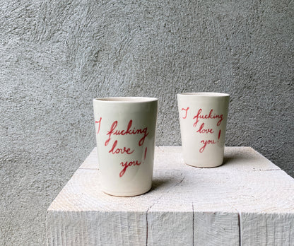 Slip casted cups in dover white (off white) and painted with red letters "I fucking love you!".

