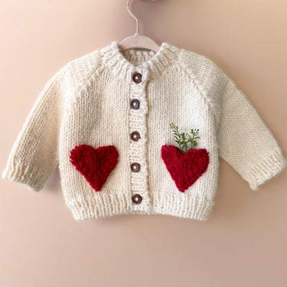 Your baby needs this chunky Cream cardigan with Red faux heart pockets. Perfect for a Valentine's Day outfit or just every day sweetness. Crafted with care using 100% Hand-knit Acrylic