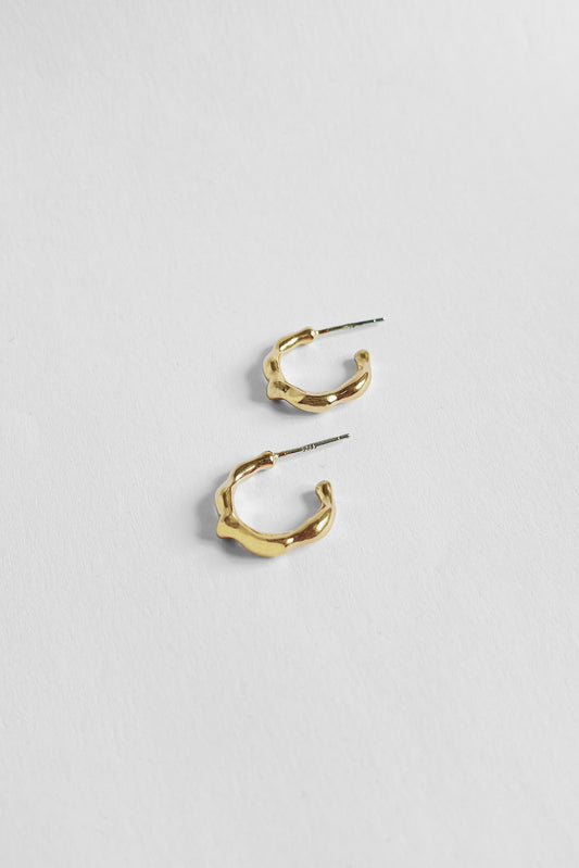 A medium-sized hoop with a nuanced organic structure. Handcast in sterling silver or gold vermeil by Kara Yoo.