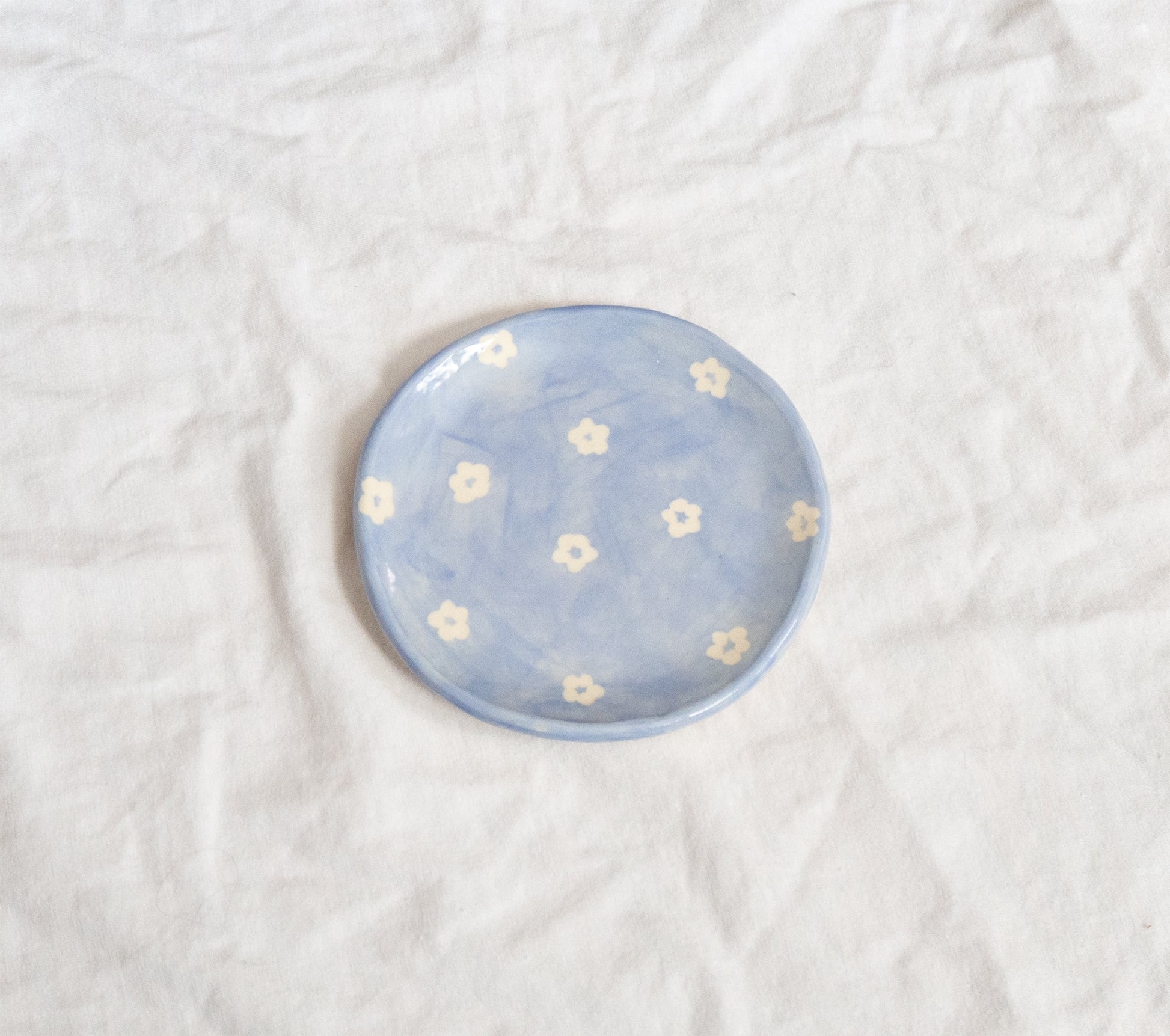 Handmade ceramic catchall plate perfect for organizing small household items, a spoon rest in the kitchen, a slice of pie, or as a home for your favorite jewelry. Thoughtfully sculpted, painted, and glazed by hand with food safe ceramic materials. Handmade in the US.