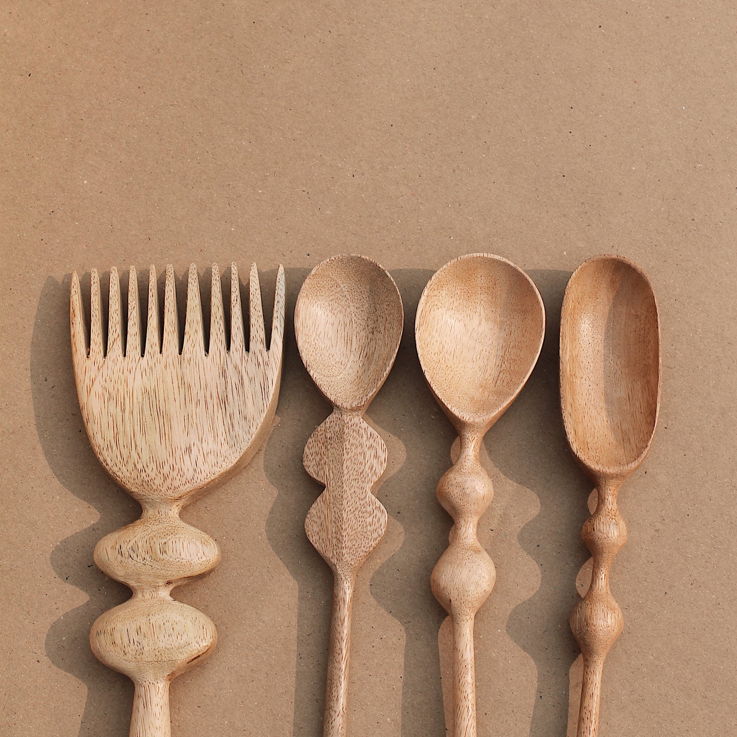 Artisans have infused these hand carved salad servers with love and creativity, featuring groovy handles for a fun and easy grip. Handmade in India.