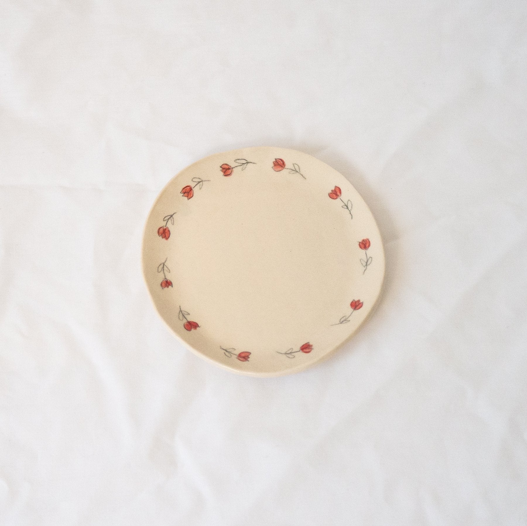 Handmade ceramic catchall plate perfect for organizing small household items, a spoon rest in the kitchen, a slice of pie, or as a home for your favorite jewelry.

Thoughtfully sculpted, painted, and glazed by hand with food safe ceramic materials. Handmade in the US.