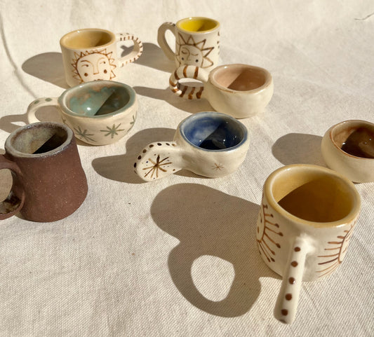 Funky tiny cups for your espresso, mezcal, sake, etc. Hand built, glazed and fired in slo, ca by roaming barefoot ceramics.
