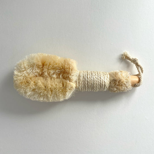 Enhance your daily skincare ritual with this stimulating body brush. Designed to be used on dry skin, its soft bristles provide gentle exfoliation as it promotes lymphatic drainage and boosts circulation. Sisal is a natural fiber from the agave sisalana plant, stronger and more durable than other natural fibers. It is resistant to bacteria, mildew, and oil.