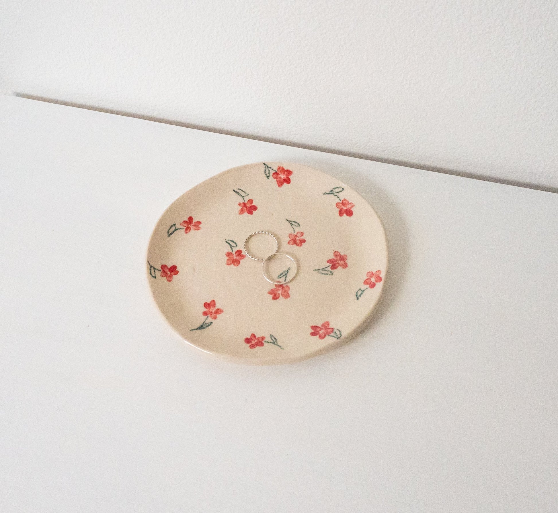 Handmade ceramic catchall plate perfect for organizing small household items, a spoon rest in the kitchen, a slice of pie, or as a home for your favorite jewelry.

Thoughtfully sculpted, painted, and glazed by hand with food safe ceramic materials.