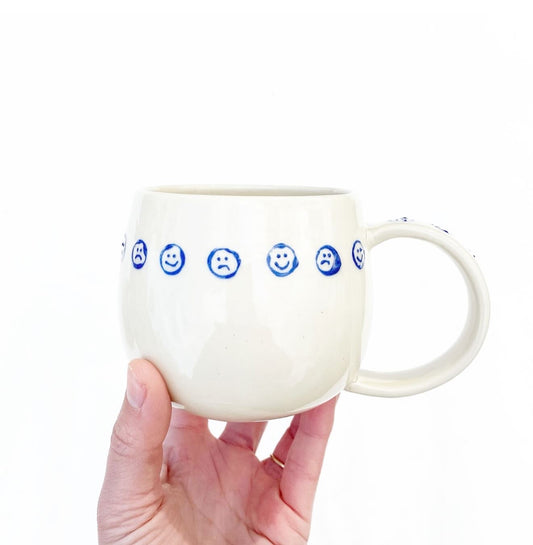 Hand-thrown cream stoneware with alternating happy sad faces in cobalt. Made in Virginia, USA by Korai Ceramics.