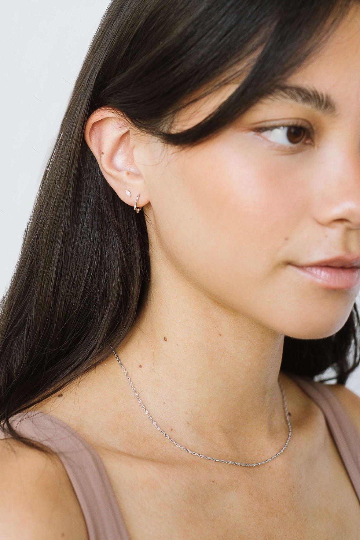 A thin round hoop with a unique wavy design.
 Handcast in sterling silver or gold vermeil by Kara Yoo.