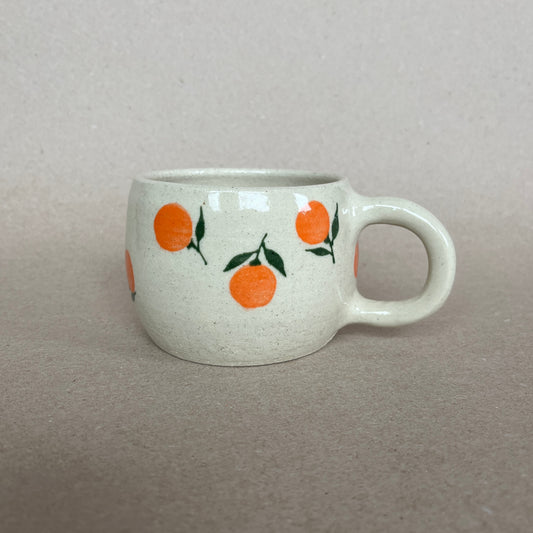 Hand painted mandarin mug is sure to start your day on a positive foot! White stoneware with clear glaze.