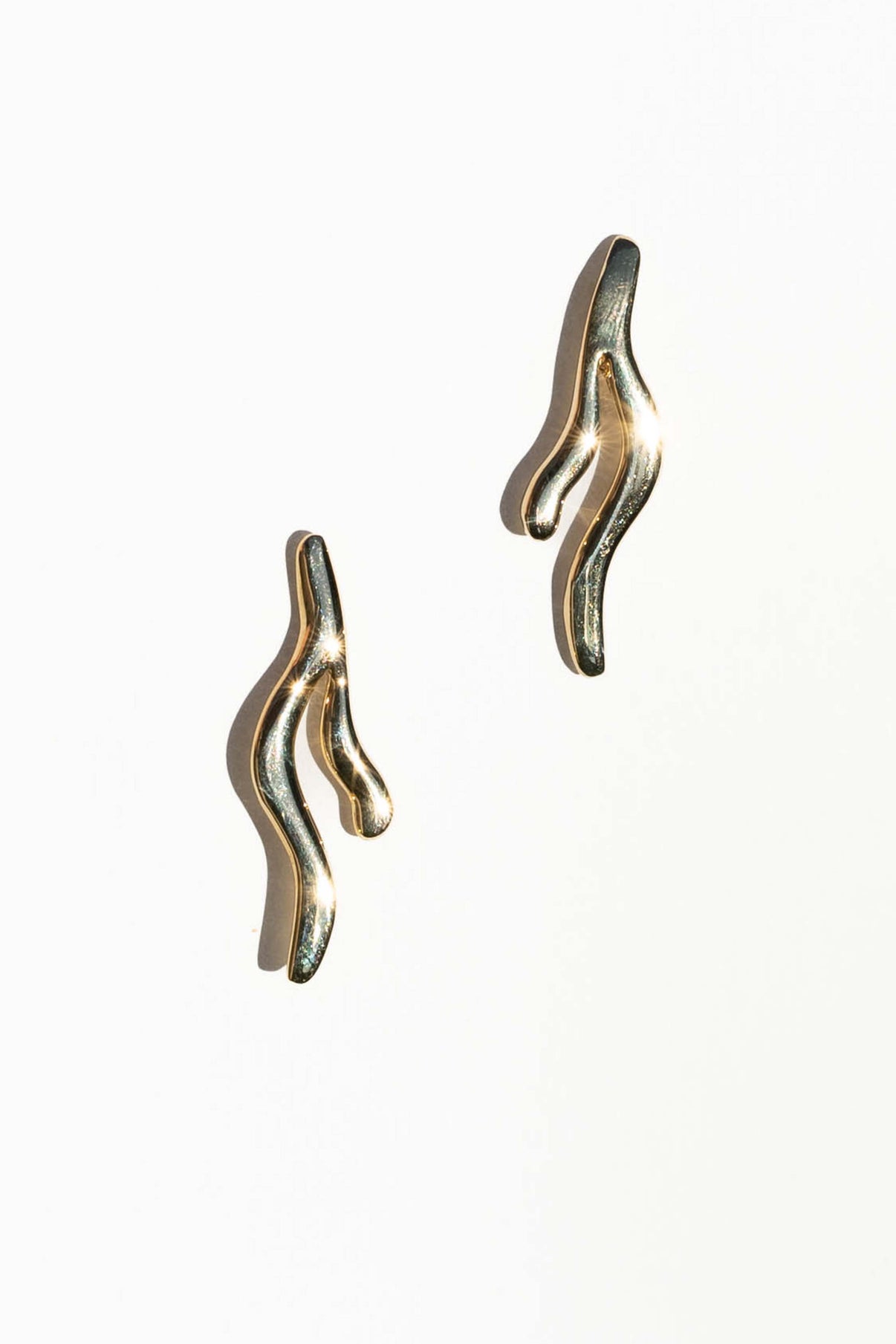 These earrings are inspired by the way seaweed blades gracefully sway underwater.  Hand carved and cast with a high polished mirror finish. Available in solid brass or sterling silver.