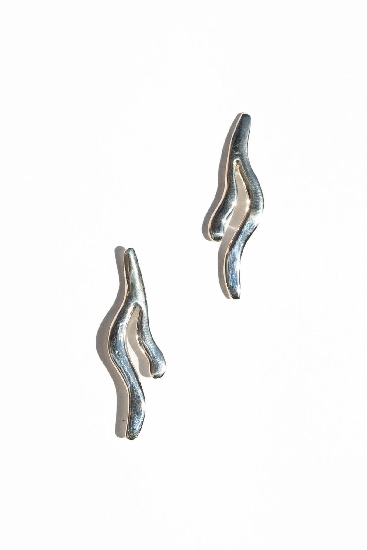 These earrings are inspired by the way seaweed blades gracefully sway underwater.  Hand carved and cast with a high polished mirror finish. Available in solid brass or sterling silver.