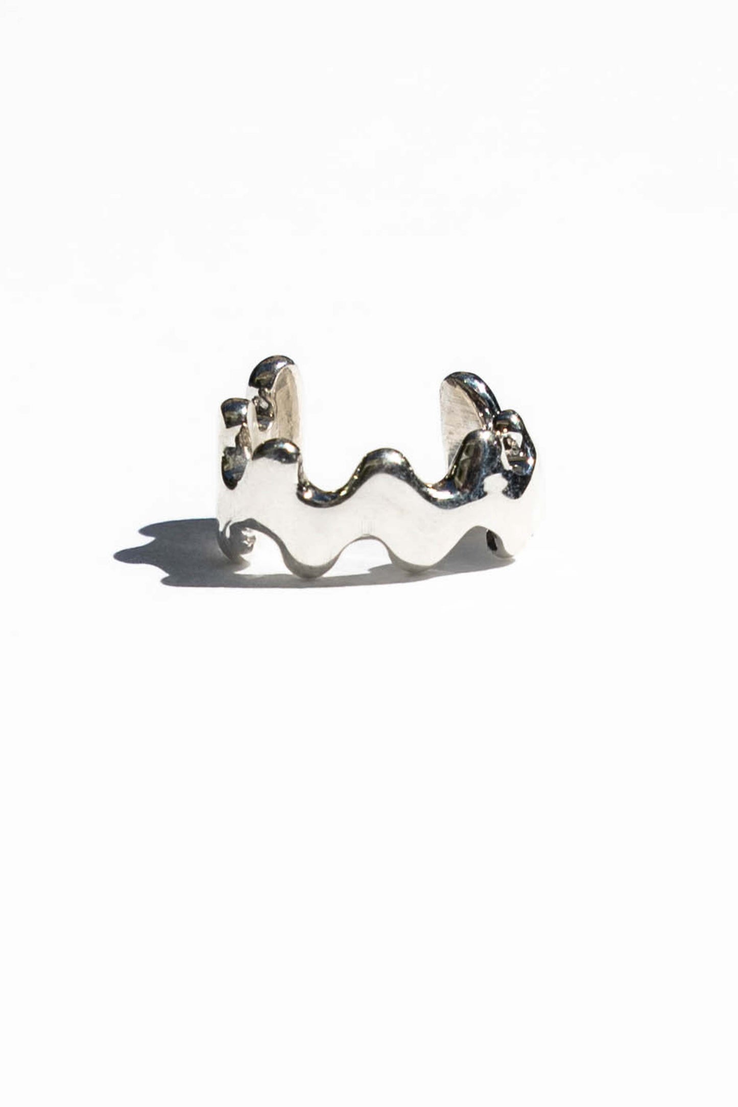 This ear cuff is inspired by the frilly wavy blade of wakame seaweed. Perfect for wearing a layered earring look without needing a piercing.  Hand carved and cast with a high polished mirror finish. Available in solid brass or sterling silver.