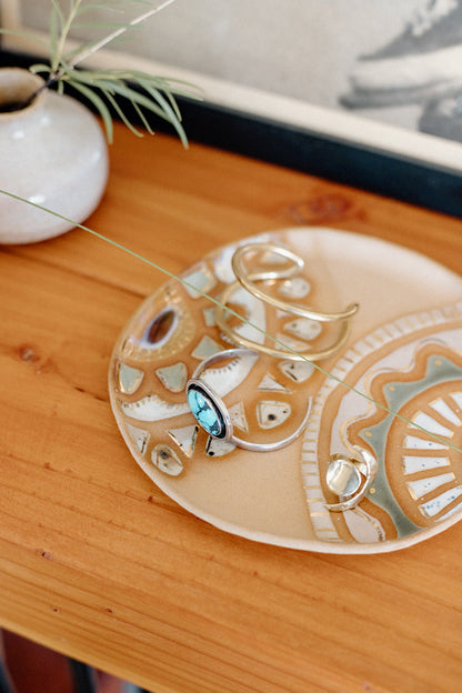 Handmade ceramic dish featuring fun designs and gold luster accents.