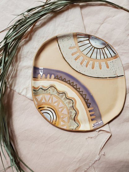 Handmade ceramic dish featuring fun designs and gold luster accents.