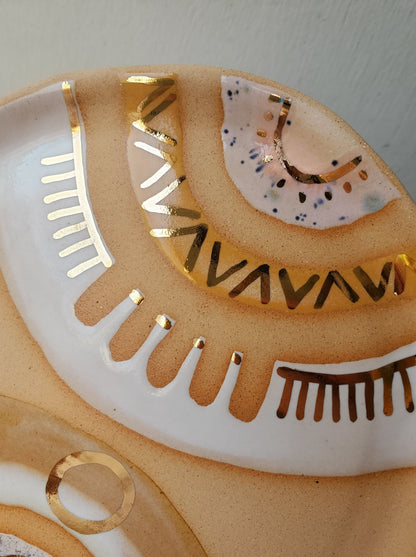 Handmade ceramic dish featuring fun designs and gold luster accents.